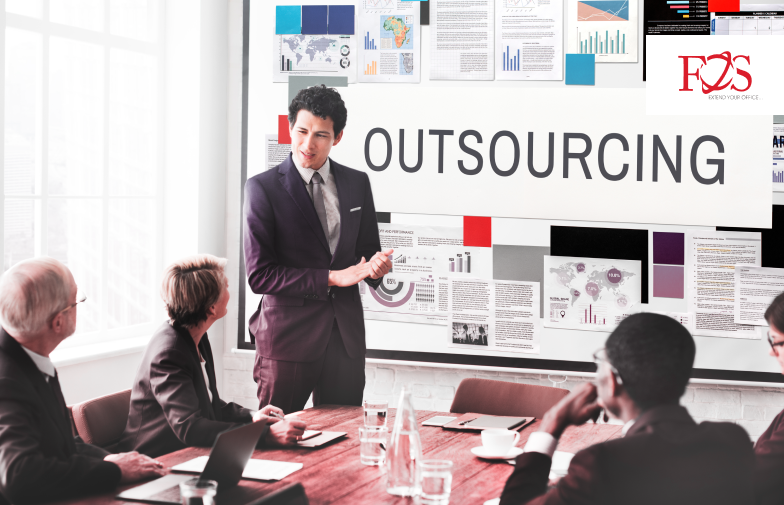 A person giving a presentation in front of a group of team member about logistic outsourcing